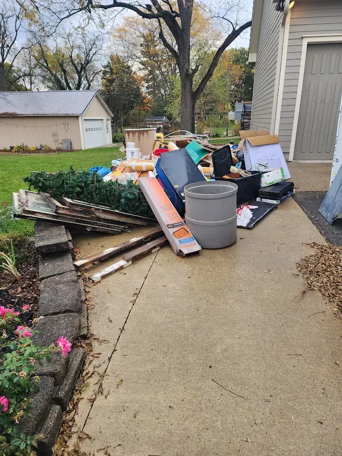 Dumpster being loaded with debris for Estate Cleanout Dumpster Rental in Ellicott City